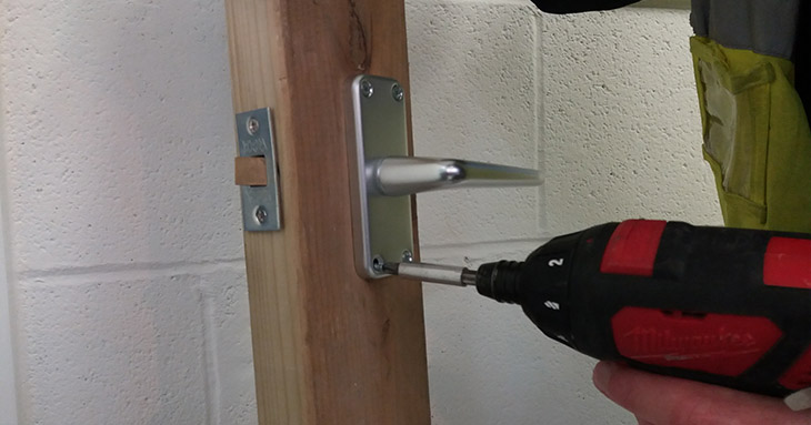Removing screws from a door handle