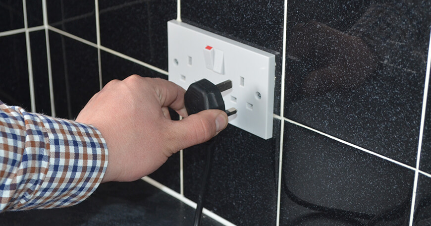 Image showing someone removing a plug from a socket