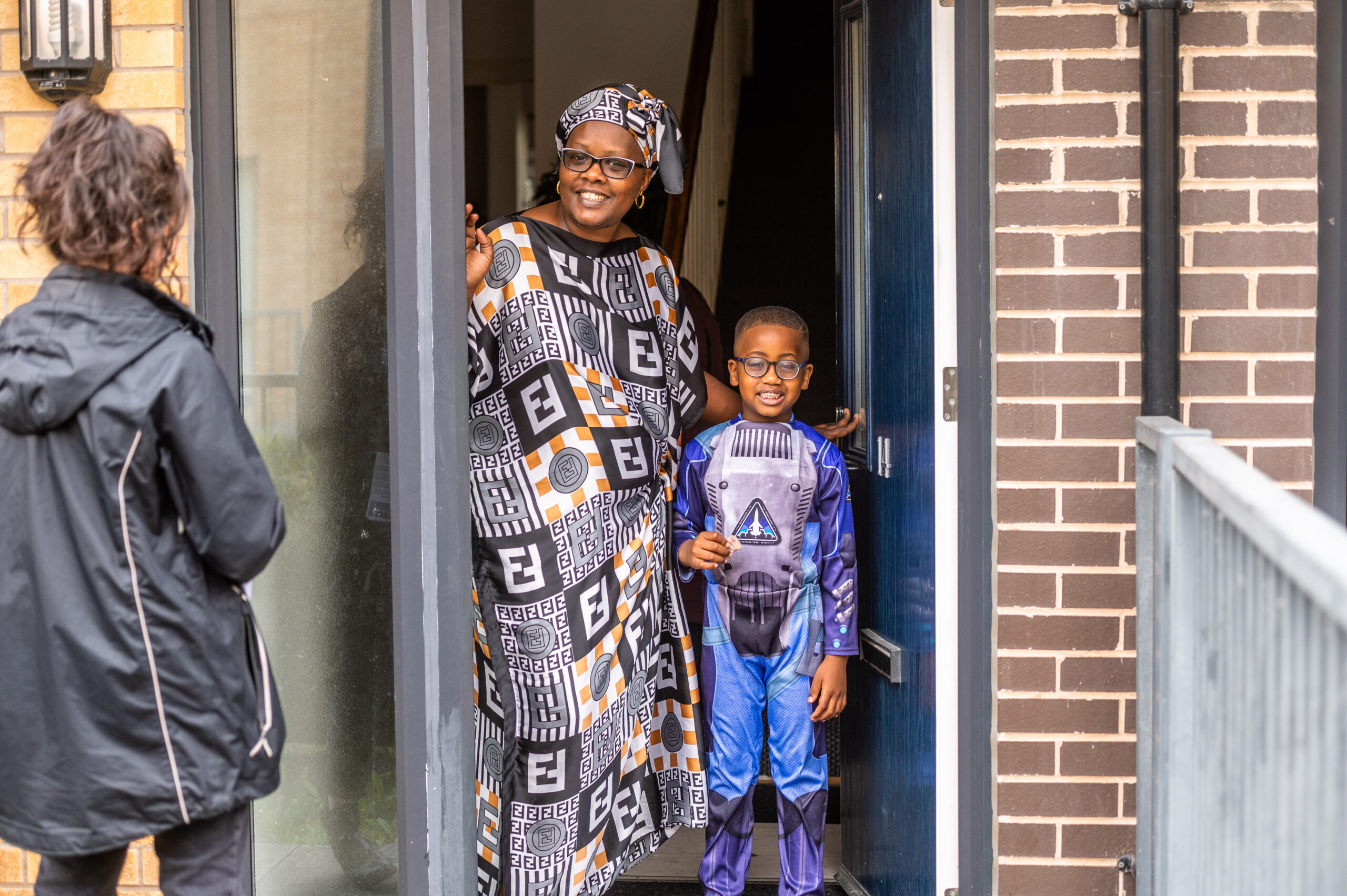 Customer with their young child in doorway