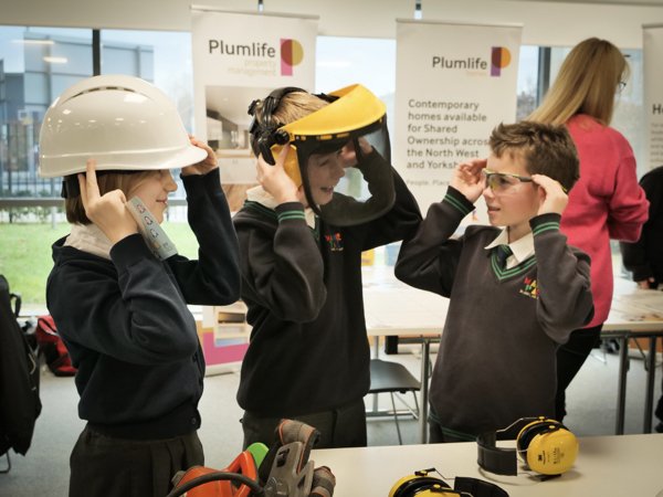 School children trying safety equipment